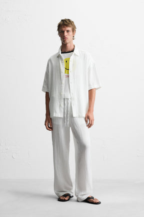 CRINKLED-EFFECT TROUSERS - Image 1
