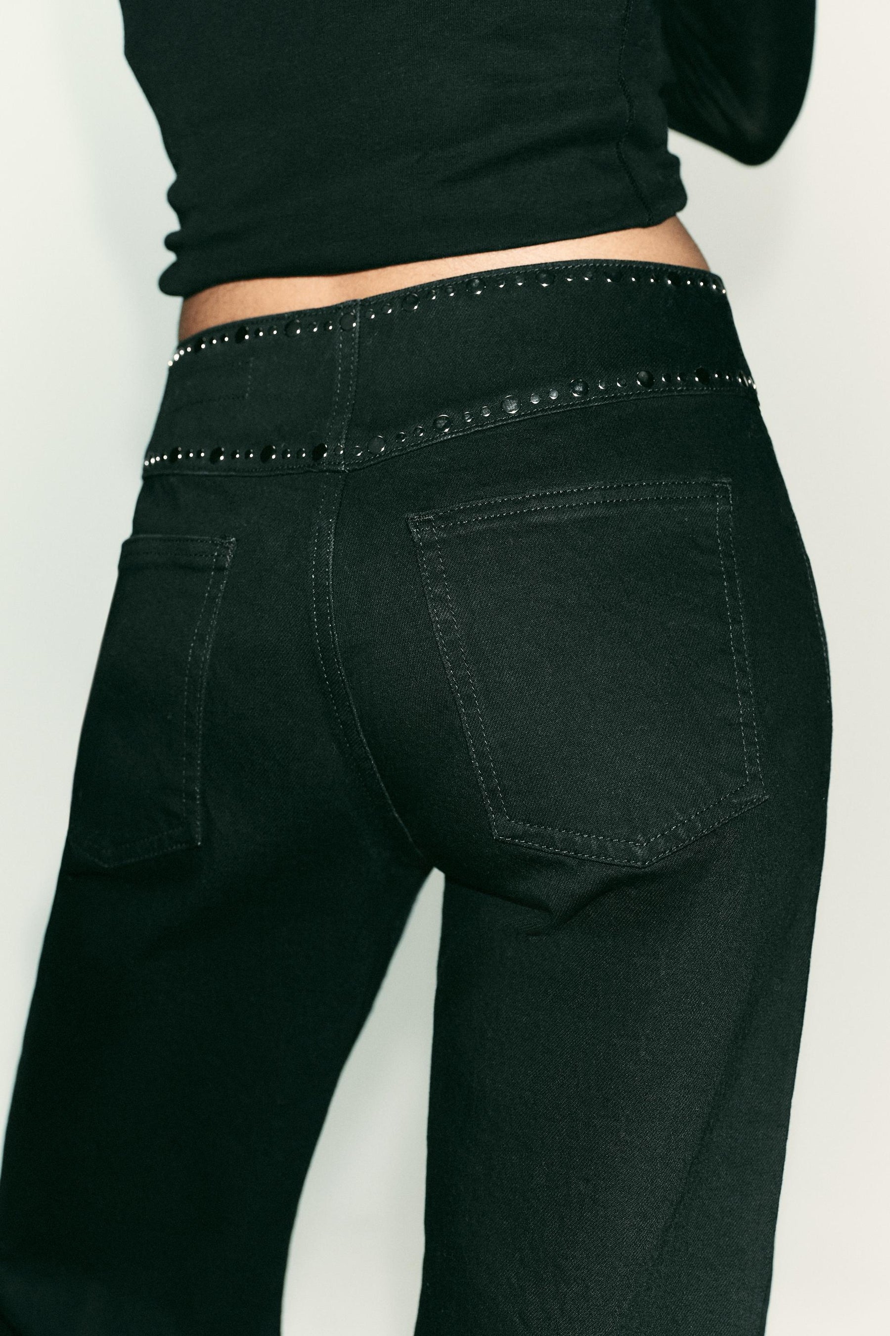 High-waist studded jeans