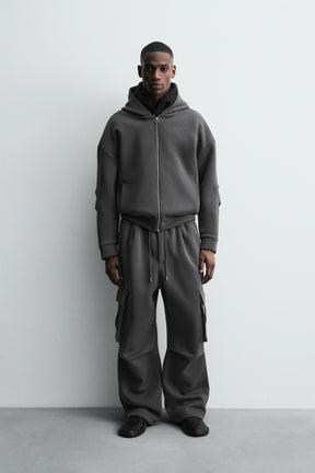 NEOPRENE-EFFECT PLEATED CARGO TROUSERS - Image 1