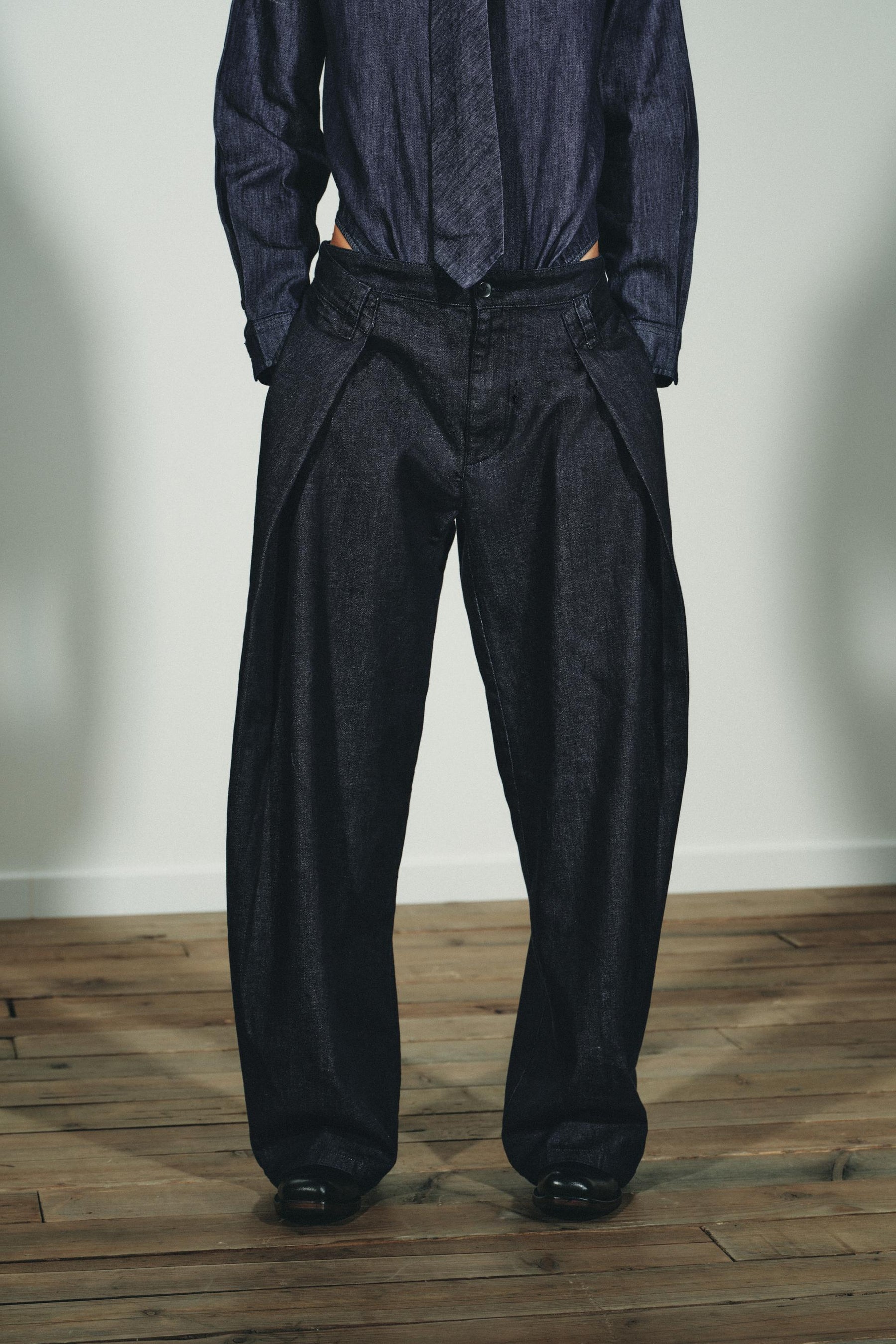 PLEATED DENIM TROUSERS