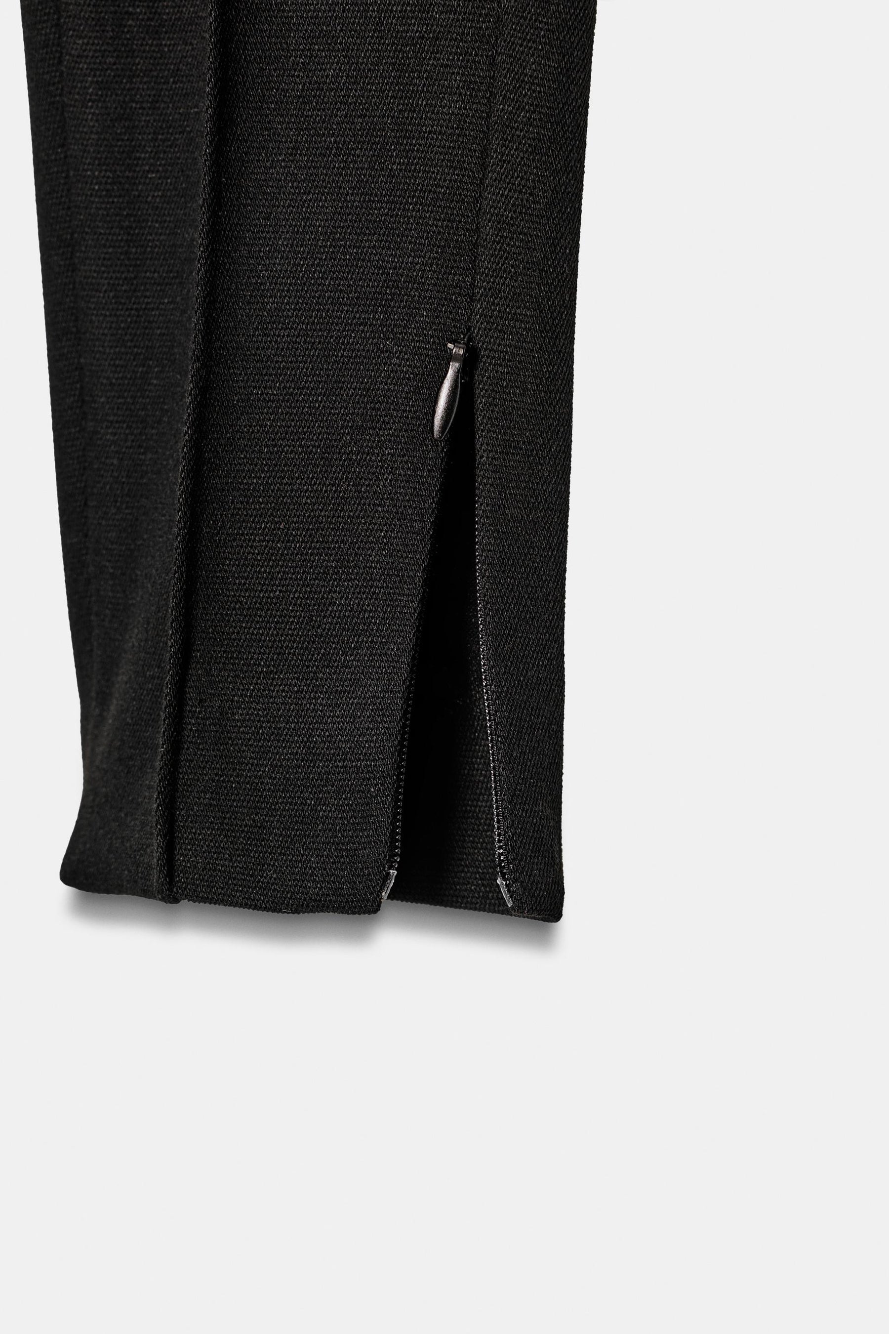Slim-fit trousers with zipped